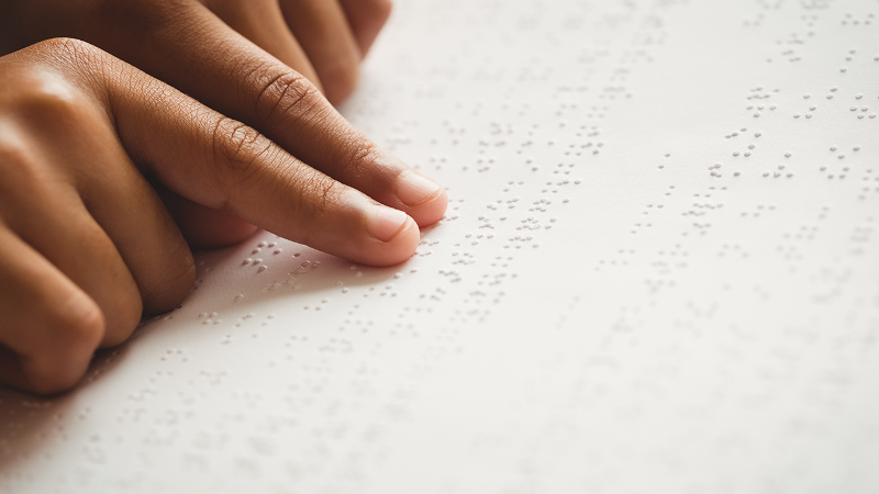 A person reading braille text