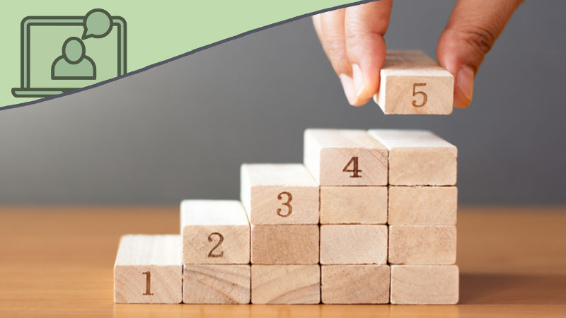 Photo of a hand placing blocks as steps, numbered one through five