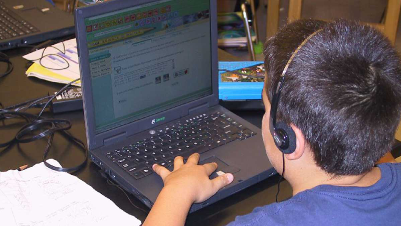 Photo of a young man using a laptop